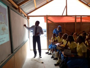 Jean-Robert Altidor, from the Bureau des Mines et de l'Energie in Haiti, presents an outreach talk to school girls in Port-au-Prince. Besides installing seismometers with Altidor and other Haitian partners after the 2010 earthquake, guest blogger Susan Hough and USGS colleagues provided training to help develop outreach and education programs. Photo by Susan Hough.