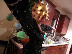 Featured here is a comprehensive solar system with sun and the planets, worn by Kathleen Thatcher. The sun is displayed with a mask and the planets hang surrounding the sun. Thatcher chose a dark pair of pajamas (“because pajamas are warm and comfortable,” Thatcher said) that have stars all over them to represent the galaxy that surrounds the solar system. Photo by Russell Weller.