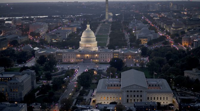 A photo of the U.S. Capitol and National Mall at night