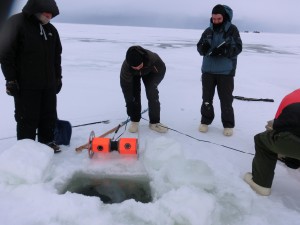 Researchers deploy a buoyant rover prototype in an ice-covered lake near Barrow, Alaska
