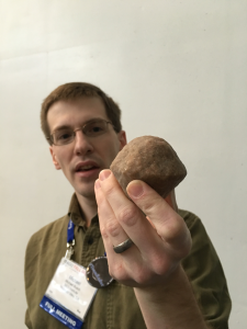 When asked about his research, Busch pulled out his go-to prop, which looks like a deformed muffin. But Busch’s prop isn’t a pastry — it’s a 3D-printed model of a 1300-foot-wide asteroid known as 2008 EV5, which could help astronomers test a technique in deflecting orbiting objects that drift dangerously close to Earth.