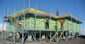 Xinzhao Chu, Jian Zhao and Cao Chen celebrate outside the Antarctica New Zealand building at Arrival Heights, Antarctica, following a season of extensive lidar observations of the high atmosphere. Credit: CIRES and CU-Boulder.