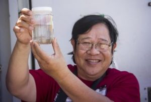 Dr. Lam Nguyen-Ngoc admires zooplankton collected in the first tow of the expedition. SOI/Mónika Naranjo González
