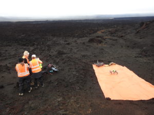 FELDSPAR 2019 team discussing a plan for drone mapping at the Holuhraun volcanic eruption site. Pictured (right to left): Anna Simpson, Carlie Novak, and Amanda Stockton of Georgia Institute of Technology. Credit: Erika Rader. 