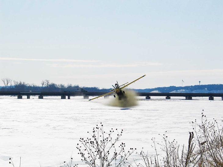 Crop duster spreading coal dust. USACE