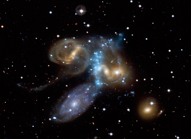 A cluster of Galaxies seen by the Chandra X-Ray Telescope. Click the image for info on what is happening here. Then come back to find out about the most distant cluster known. 