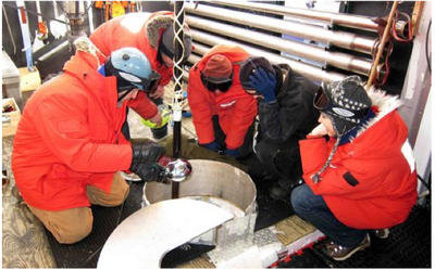 Installing a string of DOM's in Ice Cube at Amundsen Scott Station at the South Pole. Pic courtesy of Ice Cube- Univ of Wisconsin/NSF.