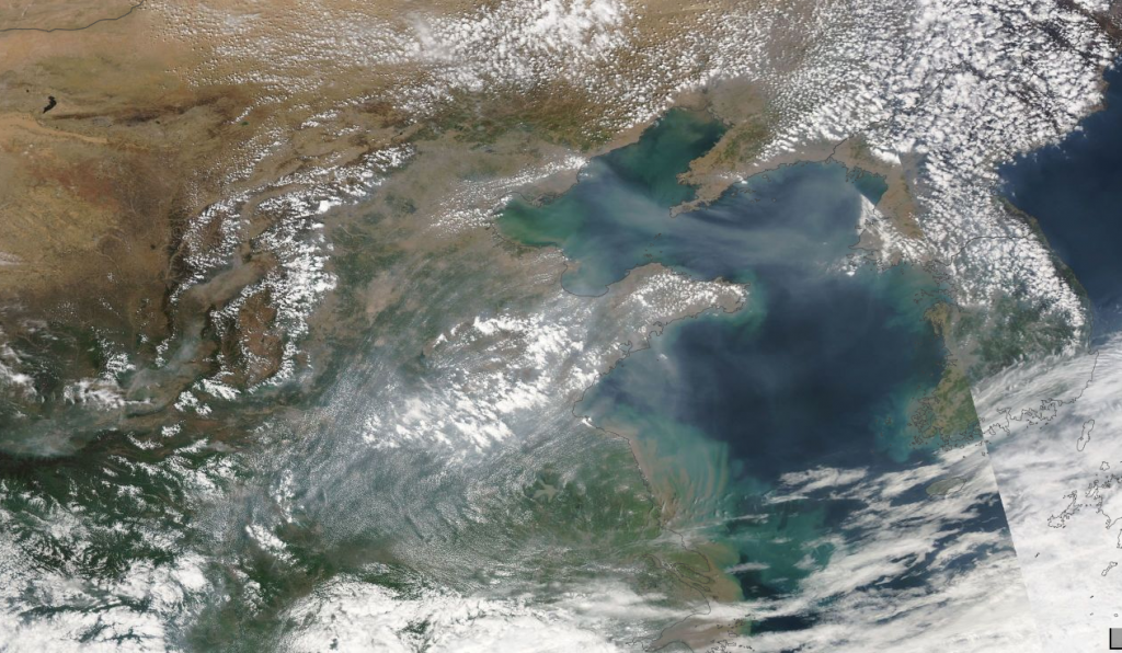 Sand and soot in NW China. A huge sandstorm caused school sto close in China. The view from Aqua shows it well. The brown cloud of soot is now almost a constant over China. One reason why they are feverishly working to get away from "clean" coal. It's choking them to death!