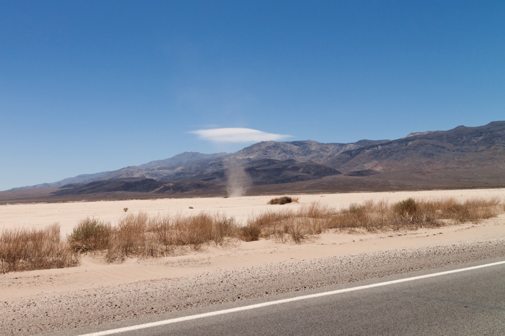 A dust devil is Death valley. These happen when rolling tubes of air get tilted upright and then stretched as hot air rises rapidly. They have NOTHING to do with tornadoes.